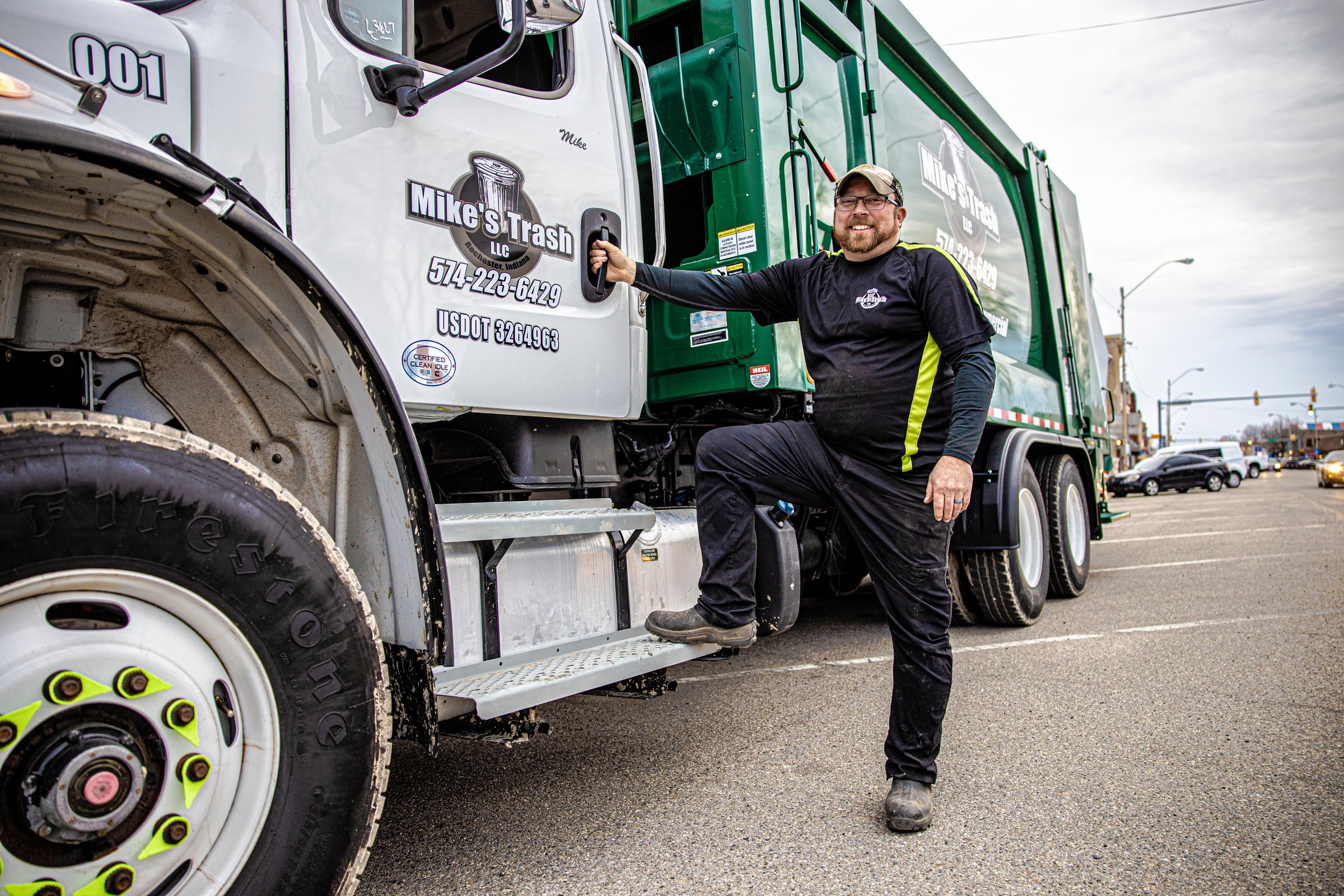 Owner with Mike's Trash truck